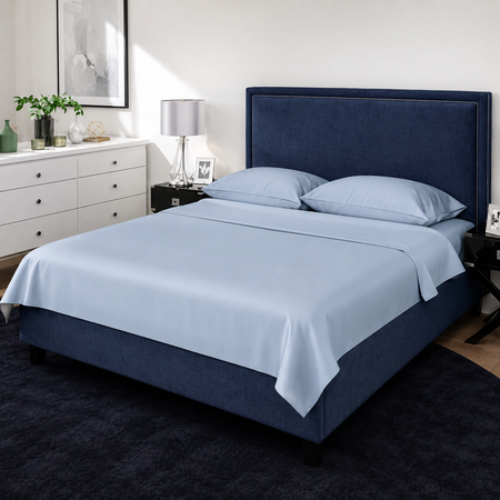 Bedroom with a blue upholstered bed and light blue bedding