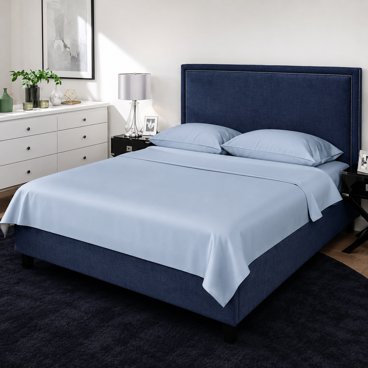 Bedroom with a blue upholstered bed and light blue bedding